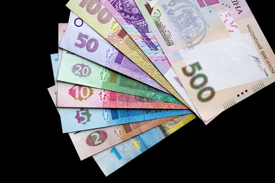 Hryvnia Ukrainian national currency on a black background. Beautiful money of Europe	
