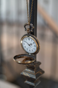 close up of a vintage pocket watch with a chain and glass lid