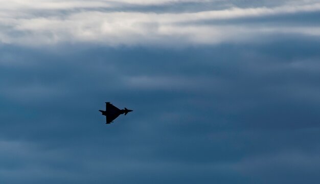 Eurofighter typhoon fighter plane during an exercise flight in the morning cloud sky of Austria