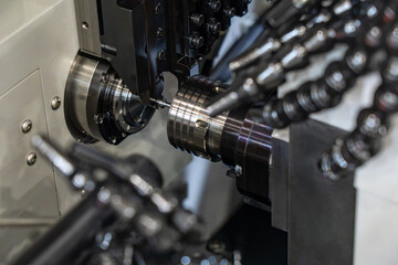 Close-up of an industrial CNC machine tool turret with precision cutting tool holder, rotating spindle assembly and multiple machining tools © Viktor Brazhnikow
