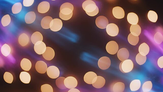 Soft bokeh lights dancing in warm golden hues with subtle blue and pink streaks during a gentle camera drift