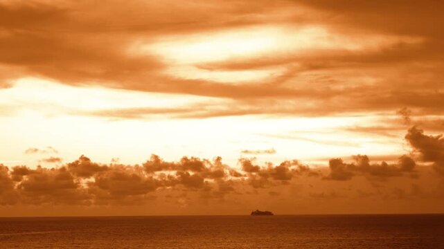 Distant Cruise Ship Silhouette on Sea Horizon at Golden Sunset