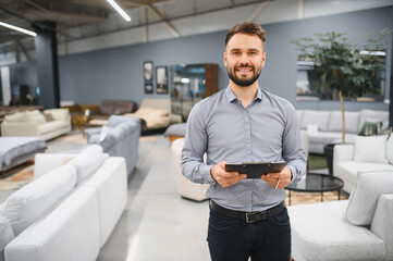 Sales consultant working in modern furniture store showroom