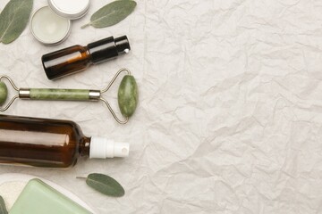 Natural skincare routine tools including stone roller and essential oil bottle with skincare © mrzn