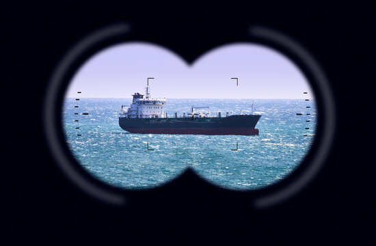 Binoculars point of view with Large crude oil tanker traveling over open ocean