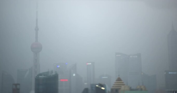 Day turns to dark night as Oriental Pearl Tower and Pudong skyscrapers switch on city lights in Shanghai, recorded with miniature tilt shift effect in timelapse