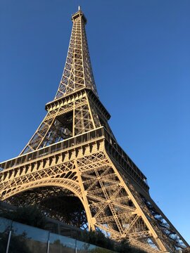 Eiffel Tower viewed from below against the sky, dramatic upward perspective of the iconic Paris landmark