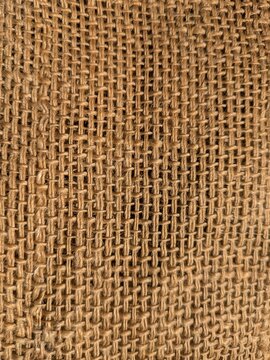Close-up of natural burlap jute fabric texture woven background vertical
