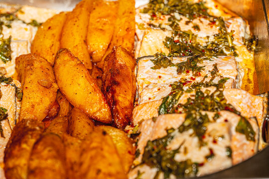 Traditional Turkish fish stew, Patatesli Balik Bugulama, baked with sliced potatoes, tomatoes, and lemon.