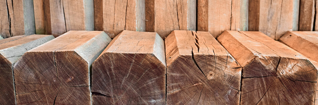 Stacked wooden beams with texture and cracks close up