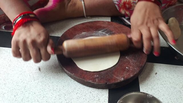 Indian Woman Rolling Fresh Dough Sheet for Gujiya Sweet Dumpling Preparation Close Up