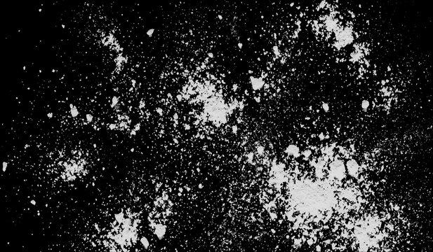White flour or powder splash isolated on black background, texture of dry dust particles scattered for overlay or design element