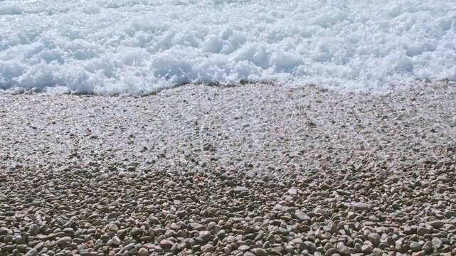 Close up of the waves hitting to the pebble beach in Nice, Provence-Alpes-C&ocirc;te d'Azur, France.