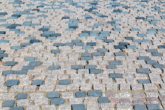 The background of the sidewalk is paved with square marble bricks.