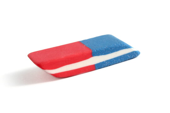 There is a school eraser lying on a white background.