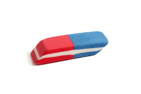 There is a school eraser lying on a white background.