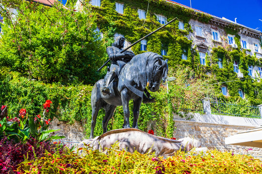 Saint George statue in front of Stone Gate surrounded by flowers in Zagreb, Croatia