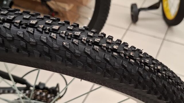 Close up of a bicycle tire with deep tread pattern. Cycling equipment, outdoor transport, sporty detail, mobility concept, active lifestyle. Bicycle shop