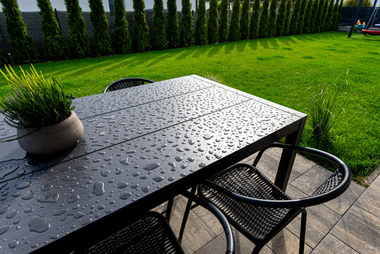 Garden table with water drops after rain