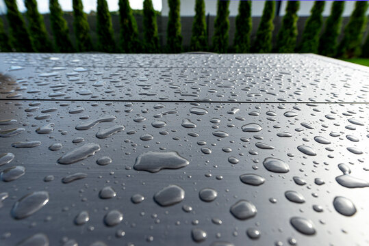Water drops covering durable composite garden table surface