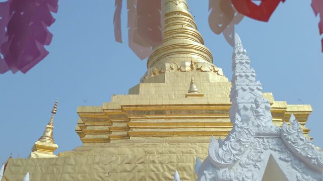 Dolly shot of the Lanna style lanterns with the Prathat Chae Haeng pagoda in Nan province, Thailand. 