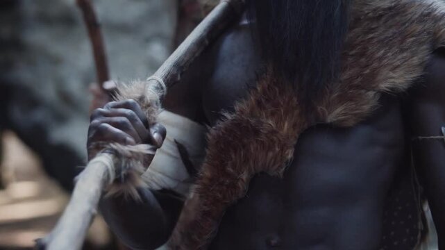 Primitive Caveman Wearing Animal Skin Walking Through Ancient Forest