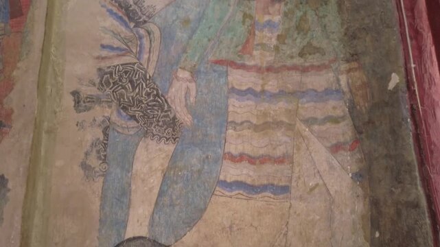 Murals with sacred and secular themes inside Wat Phumin, Nan province, Thailand.