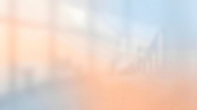 A hazy  out of focus urban scene with faint outlines of buildings and structures  bathed in gentle orange and blue hues  suggesting early morning or late evening light