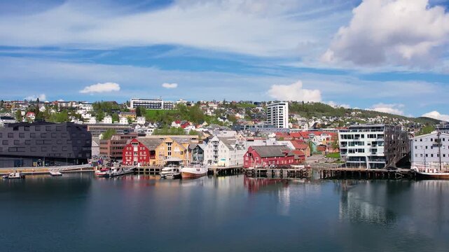 Troms Harbour features vibrant buildings and calm waters, showcasing the stunning landscape of the northern Norwegian city. This picturesque area is perfect for walking and sightseeing.