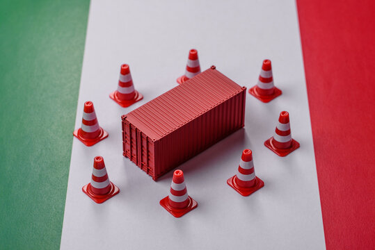 The cargo container ban on the Italian flag as a conceptual backdrop. Cargo container embargo