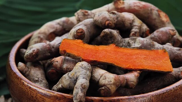 Fresh Turmeric Rhizomes in a Wooden Bowl