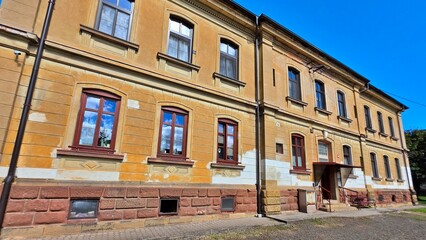 Fototapeta premium Exterior facade of historic yellow building in Mezimesti, Czech Republic