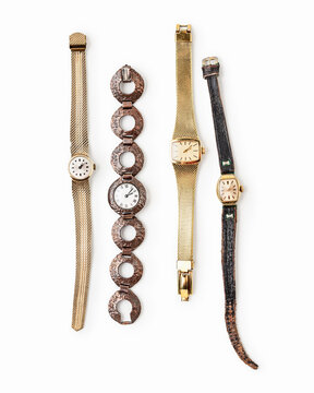Vintage wristwatches isolated on white background. Minimalist composition of four different analog watches with metal and leather straps