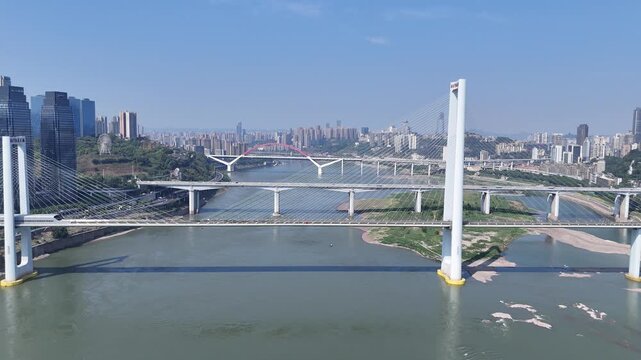 Aerial cable-stayed bridge over river cityscape