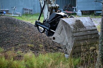 Excavator Bucket Working on Soil and Gravel © Sebastian
