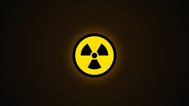 Yellow and black radioactive warning symbol rotating and glowing on dark background loop