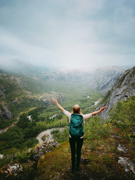 Backpacker woman travel in Norway enjoying foggy mountain valley view in Rago national park outdoor, hiking travel adventure freedom adventure exploration healthy lifestyle wild nature