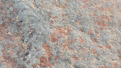 Natural weathered rock surface texture with grey and rusty orange mineral patterns ©  nur fatahillah