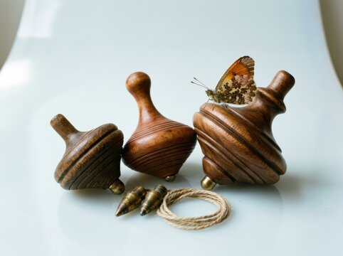 Wooden spinning tops with butterfly on a minimal light background