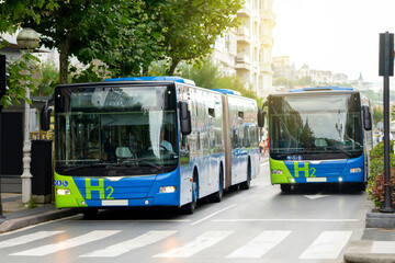 A modern hydrogen bus driving on a city street © scharfsinn86