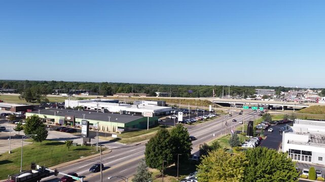 Aerial of commercial strip mall and intersection in Springfield Missouri with multiple parking lots and traffic stop