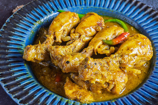 Aam Kasundi Murgi Bengali Chicken Curry with Raw Mango and Mustard Sauce Traditional Indian Style Chicken Dish Served in a Bowl