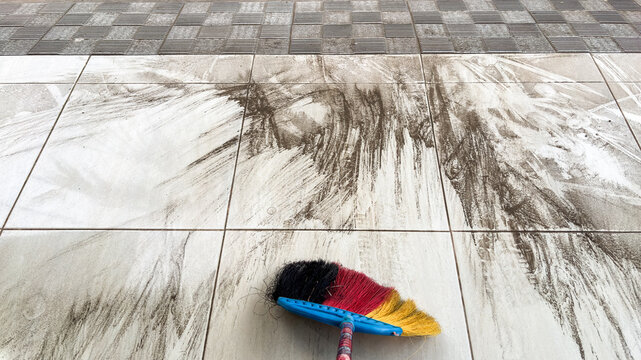 Volcanic ash covers floor, sweeping attempt with colorful broom