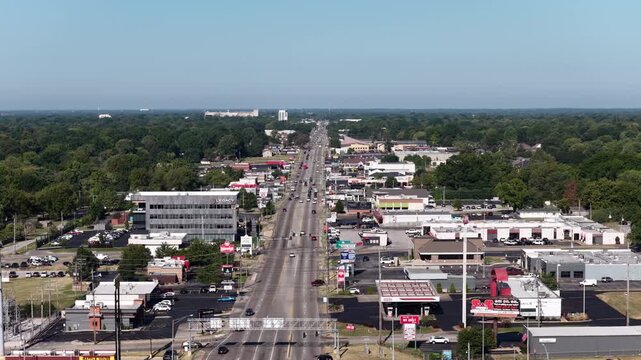 Aerial close up of commercial thoroughfare in Springfield Missouri with shopping centers and parking lots