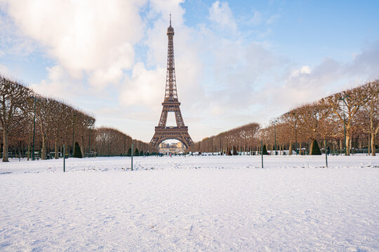 Eiffel tower in winter with snow covering champ de mars