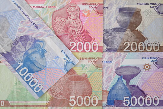 Modern Uzbekistani som (UZS) banknotes arranged together, featuring 2000, 5000, 10000, 20000, and 50000 so'm paper currency.