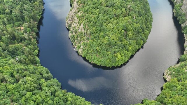 Aerial Drone Footage of Horseshoe Bend at Vltava River from Maj Lookout in Central Bohemia, Czech Republic, surrounded by Vibrant Green Summer Forest.