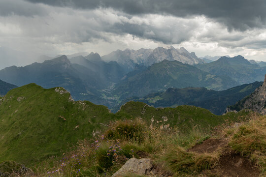 Selva di Cadore, Italy. Panoramic Dolomites mountain landscape with alpine ridge, forested valley and dramatic storm clouds