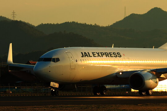 A JAL Express Boeing 767 taxis in warm golden evening light on March 22, 2014 in Japan.