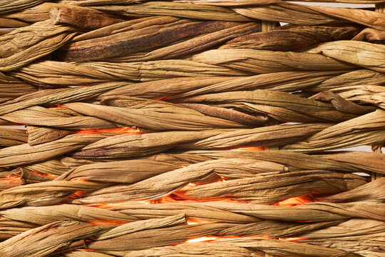 Contrast between the rustic brown fibers and the warm orange glow creates a cozy